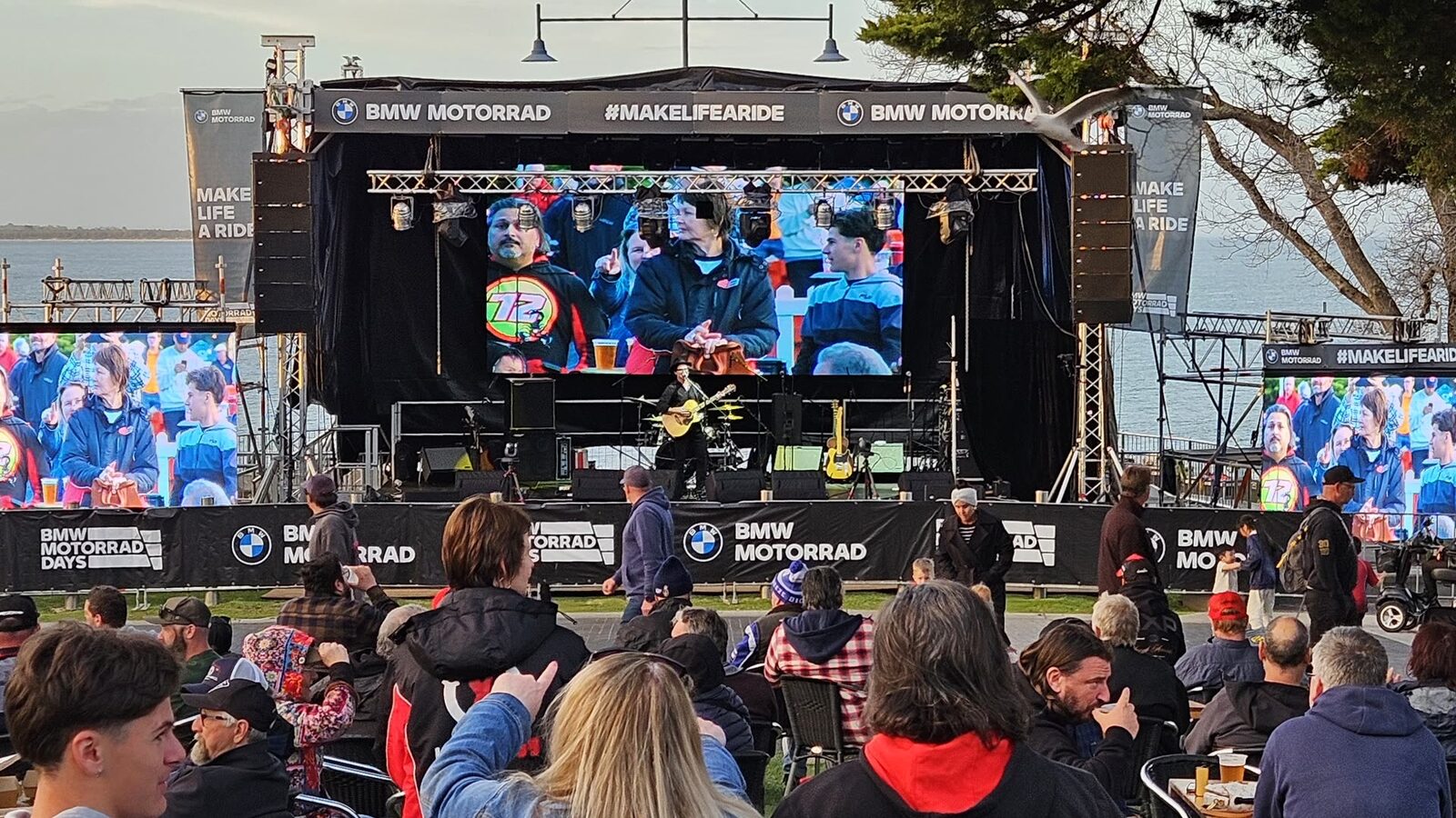 Large outdoor BMW Motorrad event stage with live screens